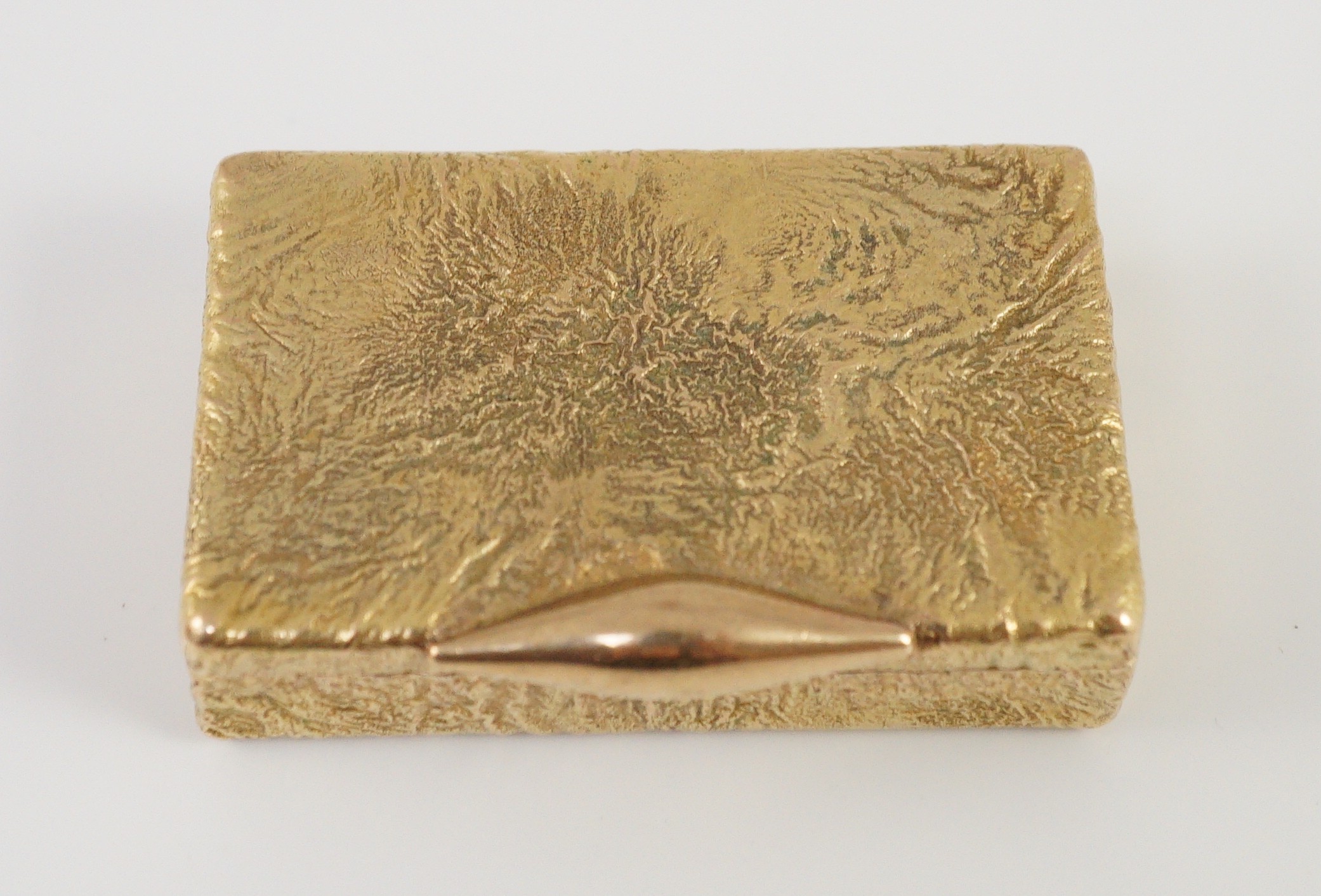 A 1960's 9ct gold Cartier rectangular pill box, with samorodok decoration